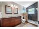 Bathroom features a double sink vanity, toilet, and tiled walk-in shower at 8514 Manassas Rd, Tampa, FL 33635