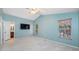 This bedroom has carpet flooring, a ceiling fan, and two windows at 8514 Manassas Rd, Tampa, FL 33635