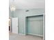 Bedroom featuring a large closet with bi-fold doors, next to the door to the bathroom at 8514 Manassas Rd, Tampa, FL 33635