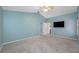 This bedroom has a ceiling fan, a TV, and access to other rooms in the home at 8514 Manassas Rd, Tampa, FL 33635