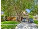 Inviting two-story home with mature trees, well-maintained lawn, and a convenient two-car driveway at 8514 Manassas Rd, Tampa, FL 33635