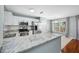 Well-lit kitchen with stainless steel appliances, granite countertops and eat in breakfast bar at 8514 Manassas Rd, Tampa, FL 33635