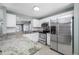 Bright kitchen features white cabinetry, stainless appliances, and granite countertops with eat in bar at 8514 Manassas Rd, Tampa, FL 33635