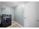 Spacious laundry room features modern washer and dryer, tile floor, and overhead shelving at 8514 Manassas Rd, Tampa, FL 33635