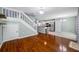 Open-concept living space with hardwood floors and staircase near the kitchen, perfect for entertaining at 8514 Manassas Rd, Tampa, FL 33635