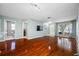 Open-concept living area showing hardwood floors, access to a bathroom and laundry room, and views into other rooms at 8514 Manassas Rd, Tampa, FL 33635