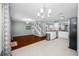 Open-concept living space with hardwood floors and staircase near the kitchen, perfect for entertaining at 8514 Manassas Rd, Tampa, FL 33635