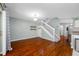 Spacious living room with hardwood floors and a staircase, offering a warm and inviting atmosphere at 8514 Manassas Rd, Tampa, FL 33635