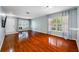 Expansive living room featuring hardwood floors, natural light, and a seamless transition to other areas of the home at 8514 Manassas Rd, Tampa, FL 33635