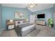 Stylishly furnished main bedroom with a vaulted ceiling, ceiling fan, and TV at 8514 Manassas Rd, Tampa, FL 33635