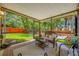 Inviting screened porch with comfortable seating and lighting overlooks the backyard with its wooden fence at 8514 Manassas Rd, Tampa, FL 33635