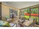 Comfortable screened porch with stylish seating, ceiling lights and outdoor views of the yard and wooden fence at 8514 Manassas Rd, Tampa, FL 33635