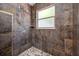 Close up of updated walk-in shower with tiled walls and floor, and two shower heads at 8514 Manassas Rd, Tampa, FL 33635