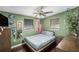 Cozy bedroom featuring hardwood floors, modern ceiling fan, and Philadelphia Eagles decor at 8556 91St Ter, Seminole, FL 33777