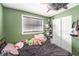 Messy bedroom with closet, ceiling fan, green walls, and a window at 8556 91St Ter, Seminole, FL 33777