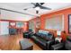 Spacious living room featuring hardwood floors, comfortable seating, and ample natural light from the large windows at 8556 91St Ter, Seminole, FL 33777