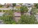 Aerial view of the property showing a single-story home nestled among mature trees and landscaping at 9213 W Robson St, Tampa, FL 33615