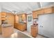 Traditional kitchen with wooden cabinets, tile floors, and a door to the outside at 9213 W Robson St, Tampa, FL 33615