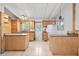 Bright kitchen features tile flooring, wooden cabinetry, and a double island setup with an exterior door at 9213 W Robson St, Tampa, FL 33615