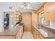 Traditional kitchen with wooden cabinets, tile floors, and stainless-steel sink at 9213 W Robson St, Tampa, FL 33615