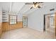 The living room has tile floors, wood paneling, and a ceiling fan at 9213 W Robson St, Tampa, FL 33615