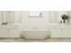 Bright bathroom with a standalone tub, dual vanities, and modern fixtures, perfect for relaxation at 9604 Runaway Breeze Dr, Land O Lakes, FL 34637