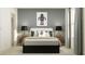 A cozy bedroom featuring a bed with stylish robot artwork above and a window with natural light at 9604 Runaway Breeze Dr, Land O Lakes, FL 34637