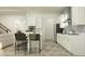 Modern kitchen with white cabinets, stainless steel appliances, and an open design for entertaining at 9604 Runaway Breeze Dr, Land O Lakes, FL 34637
