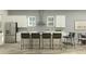 A modern kitchen offers an open design with stainless steel appliances and a kitchen island with bar seating at 9604 Runaway Breeze Dr, Land O Lakes, FL 34637