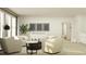 Sunlit living room featuring modern seating, neutral tones, and minimalist artwork for a serene atmosphere at 9604 Runaway Breeze Dr, Land O Lakes, FL 34637