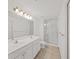 Bright bathroom featuring double sink vanity and glass shower with tile flooring at 9731 Meadow Field Cir, Tampa, FL 33626