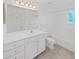 The bathroom features a white vanity with drawers, a large mirror, and a shower-tub combo, all illuminated by bright lighting at 9731 Meadow Field Cir, Tampa, FL 33626