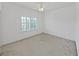 Light bedroom with ceiling fan, plantation shutters, and neutral carpeting at 9731 Meadow Field Cir, Tampa, FL 33626