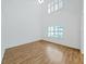 Bright bedroom with vaulted ceiling featuring large windows with plantation shutters and hardwood floors at 9731 Meadow Field Cir, Tampa, FL 33626