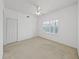 Bright bedroom with carpet, featuring large windows with plantation shutters and ceiling fan at 9731 Meadow Field Cir, Tampa, FL 33626