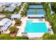 Aerial view of a community pool with tennis courts in the background at 9731 Meadow Field Cir, Tampa, FL 33626