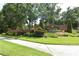 Community entrance featuring brick signage, manicured shrubs and flowerbeds at 9731 Meadow Field Cir, Tampa, FL 33626
