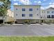 Three-story townhome with two-car garage and manicured landscaping; sunny facade at 9731 Meadow Field Cir, Tampa, FL 33626