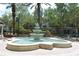 Community fountain surrounded by lush landscaping and shady trees at 9731 Meadow Field Cir, Tampa, FL 33626