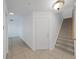 Hallway featuring a staircase and beautiful ceramic tile flooring throughout at 9731 Meadow Field Cir, Tampa, FL 33626