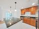 Bright kitchen featuring a large island, pendant lighting, and modern appliances, perfect for cooking at 9731 Meadow Field Cir, Tampa, FL 33626