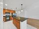 Well-equipped kitchen boasts an island with dark countertops, stainless steel appliances, and ample storage at 9731 Meadow Field Cir, Tampa, FL 33626