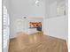 Bright living room with vaulted ceiling featuring stairs to loft and kitchen view with hardwood floors at 9731 Meadow Field Cir, Tampa, FL 33626
