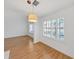 Bright living room with hardwood floors and large windows featuring plantation shutters and modern pendant lighting at 9731 Meadow Field Cir, Tampa, FL 33626