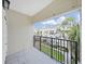 Covered balcony has an iron railing and pleasant views of the neighborhood's landscaping at 9731 Meadow Field Cir, Tampa, FL 33626