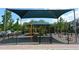 Community playground featuring climbing equipment, swings, and picnic benches at 9731 Meadow Field Cir, Tampa, FL 33626
