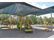 Community playground with covered seating and climbing structures at 9731 Meadow Field Cir, Tampa, FL 33626