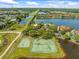 Aerial view showcasing community amenities including tennis and basketball courts at 9842 Lake Chase Island Way, Tampa, FL 33626