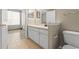 Bright bathroom featuring a white vanity, tile floor, and neutral paint at 9842 Lake Chase Island Way, Tampa, FL 33626