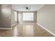 Inviting bedroom with neutral walls, wood-look floors, and a ceiling fan at 9842 Lake Chase Island Way, Tampa, FL 33626